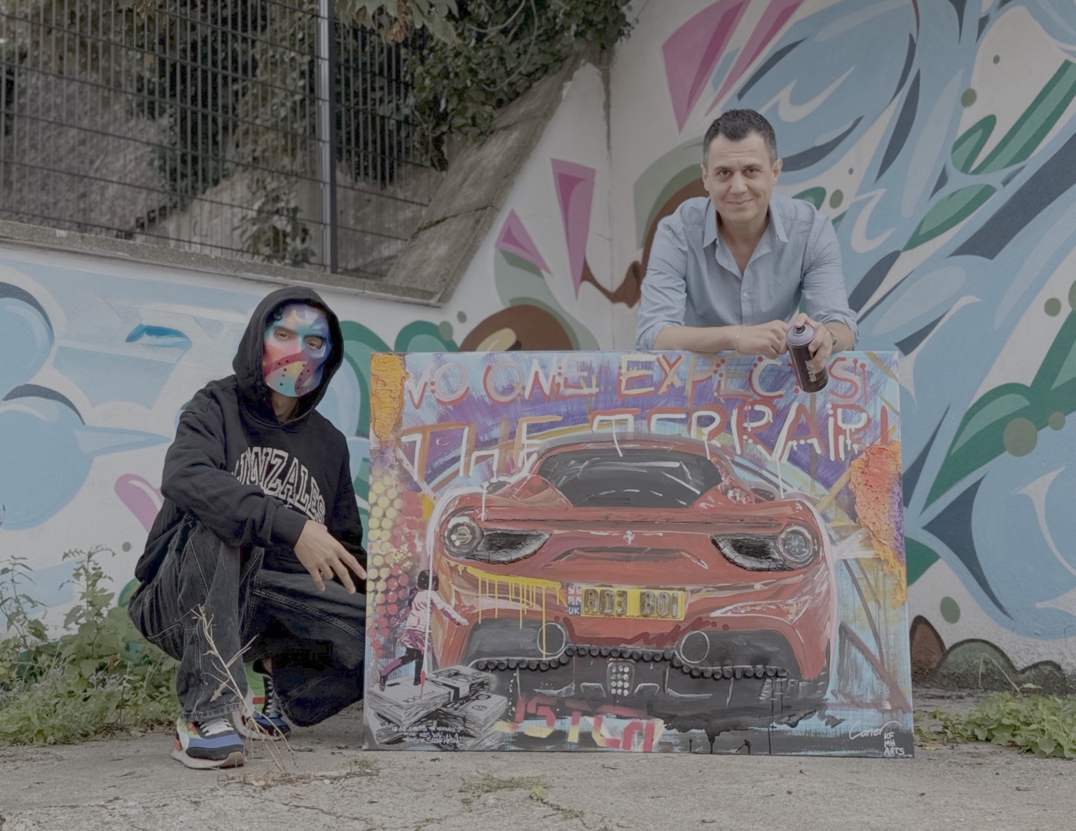 Caner Proske with a local artist and collaborative automotive artwork