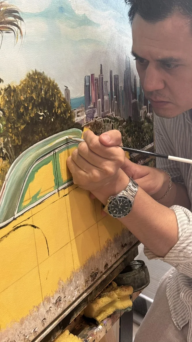 Caner Proske painting details on an automotive artwork