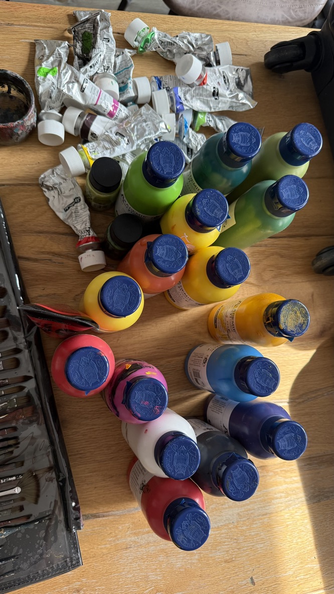 Acrylic colours and used paint tubes on the studio table
